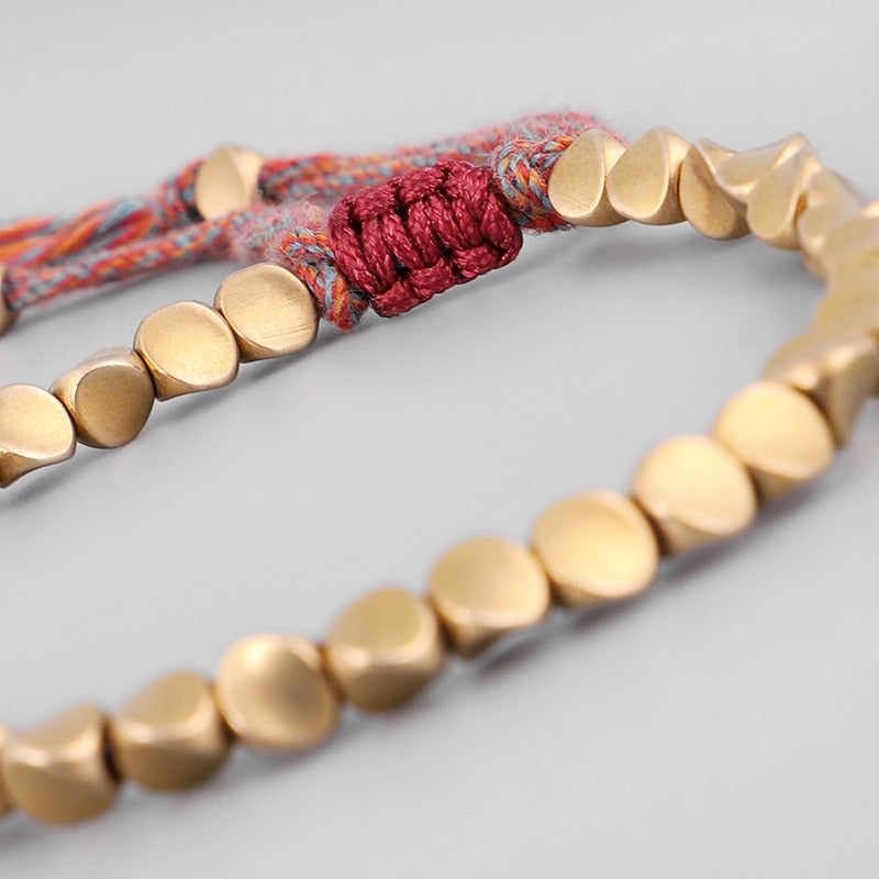"Embrace Serenity, Wear Eternity: Experience the Spiritual Connection of our Handmade Tibetan Buddhist Braided Copper Beads Lucky Rope Bracelet"
