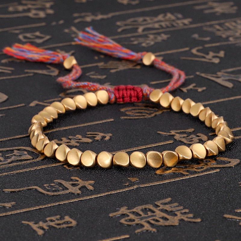 "Embrace Serenity, Wear Eternity: Experience the Spiritual Connection of our Handmade Tibetan Buddhist Braided Copper Beads Lucky Rope Bracelet"